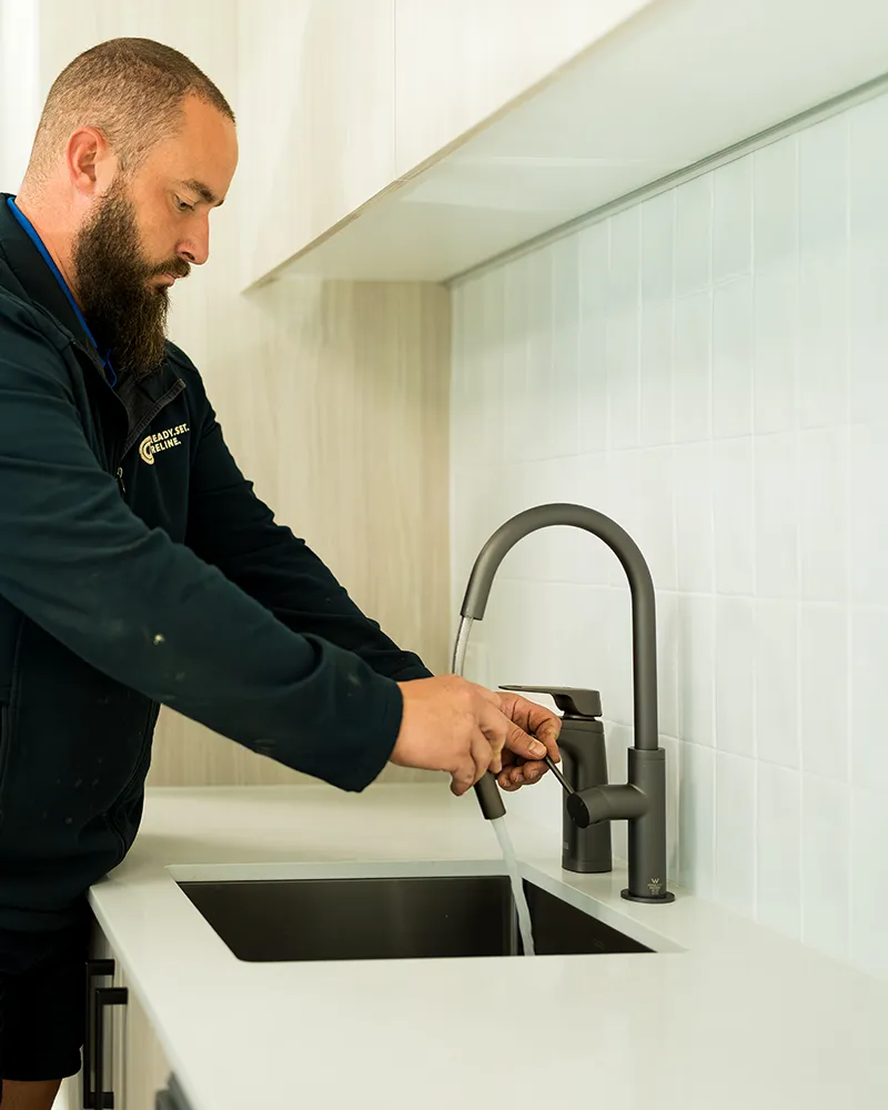 Commercial-plumber-fixing-tap Installing a water filter
