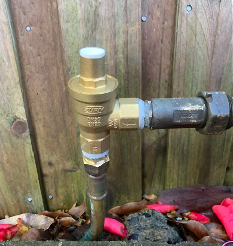 New pressure limiting valve fitted at the water meter to reduce mains pressure